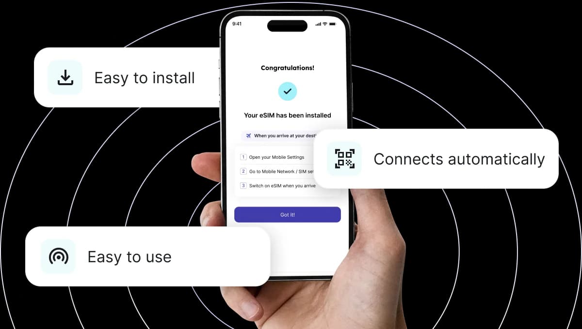 A hand holding a smartphone with the Jetpac Global app showing eSIM destinations